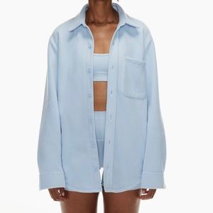 Women’s light blue fleece Aritzia button-up jacket.